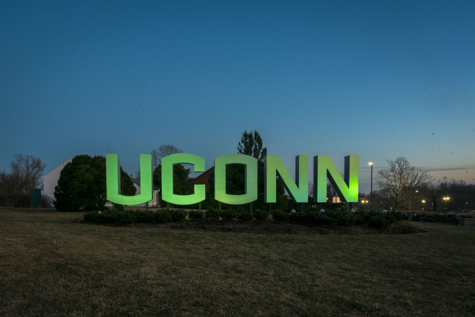 Entryway sign lit up green for St. Patricks Day and for Sustainability.